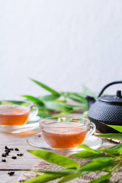 istock Cup of hot green tea on a wooden table 1243141476