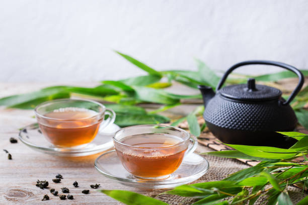 istock Cup of hot green tea on a wooden table 1243142030