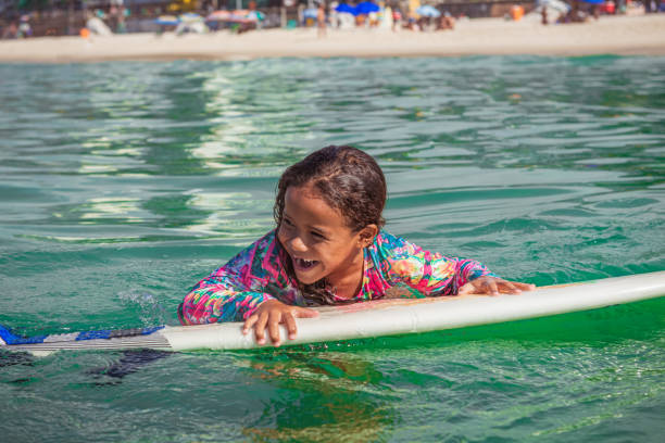 istock Beautiful little surfer on surfboard 1243143662