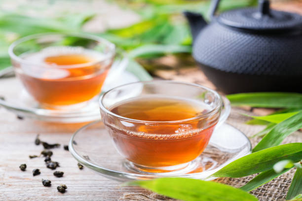 istock Cup of hot green tea on a wooden table 1243147552