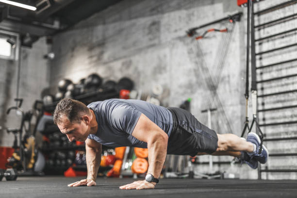 istock TRX training, Sports man doing abs exercise in a gym 1243148139