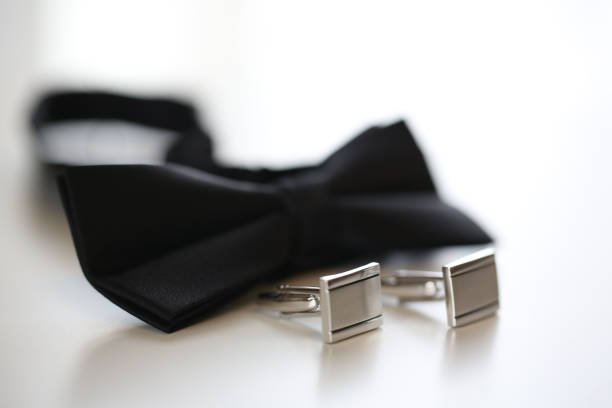 istock Black bow-tie and silver cuff links on isolated background 1243152026