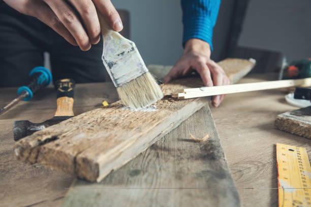 istock worker man hand brush paint wood 1243158212