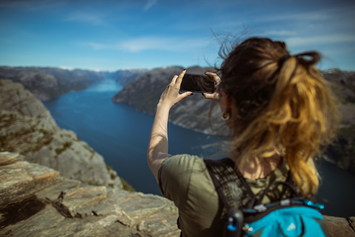 Scenics landmark of Norway: the mountain cliff on Preikestolen over fjord after the long Covid-19 lockdown
