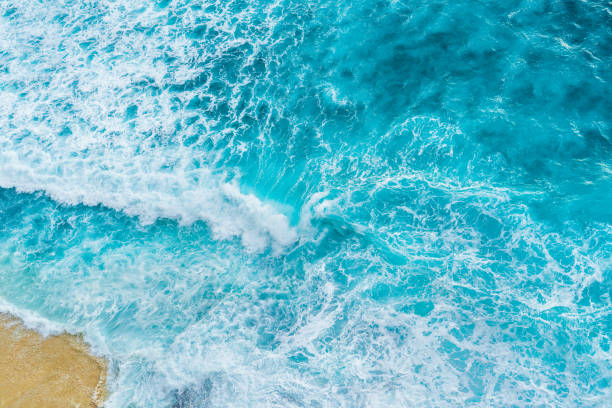 istock Big ocean waves hitting a sandy beach. View from above. 1243187206