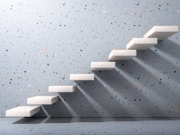 istock White stone stairs on gray terrazzo wall in modern interior. Business growth, progress and achievement creative concept. Minimalist 3D render 1243192321