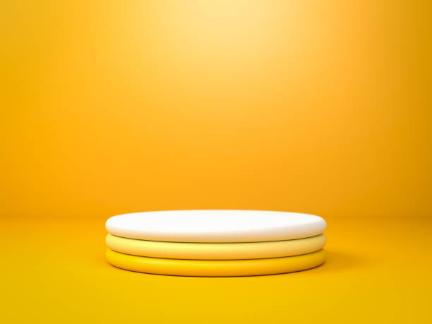 istock Round yellow gradient stage, podium or pedestal over yellow paper background in studio. 3d render. Background or mockup for cosmetics or fashion. Use for product identity, branding and presenting. Place your object or product on pedestal. 1243193404