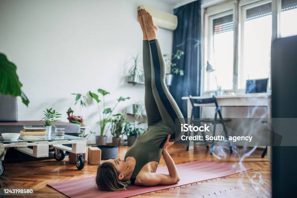 Woman Lying On Upper Back And Holding Her Lower Back In Balance Stock Photo - Download Image Now