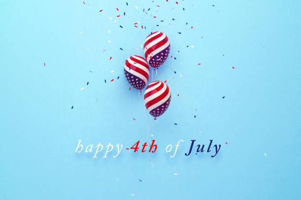 istock Remember and Honor Memorial Day Message Next to Tiny American Flag Pair Sitting on Blue Background 1243201456