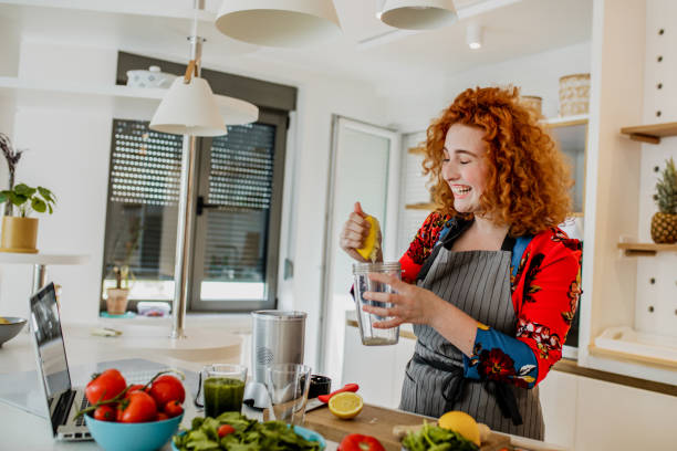 istock Young woman prepares a healthy drink 1243202058