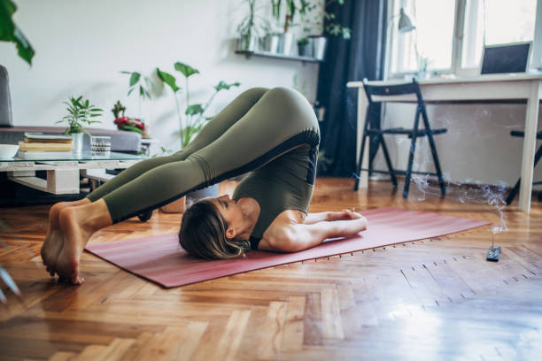 istock One woman standing in Plough pose 1243208899