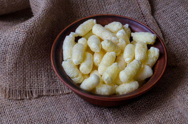 istock A brown clay bowl full of puffcorn. 1243214344