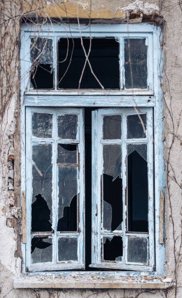 istock Window of an empty abandoned old building with broken glasses 1243219800