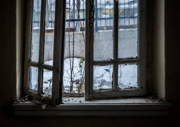 istock Window of an empty abandoned old building with broken glasses 1243219806