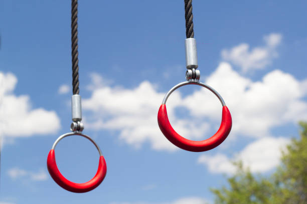 Gymnastic rings hanging in sunlight. cloudy sky in the background