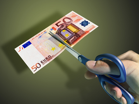 Male hand using some scissors to cut a 50 euro bill. Digital illustration, clipping path included.
