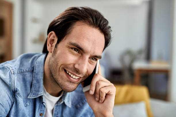 istock Happy man talking on mobile phone at home. 1243246111