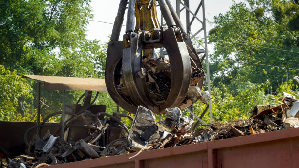 istock Special hydraulic claw lifting and destroying metal on scrapyard 1243246153