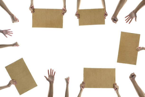 istock hand holding a blank placard to put the text at protesting with hands raised in the air. isolated on white background. 1243246193