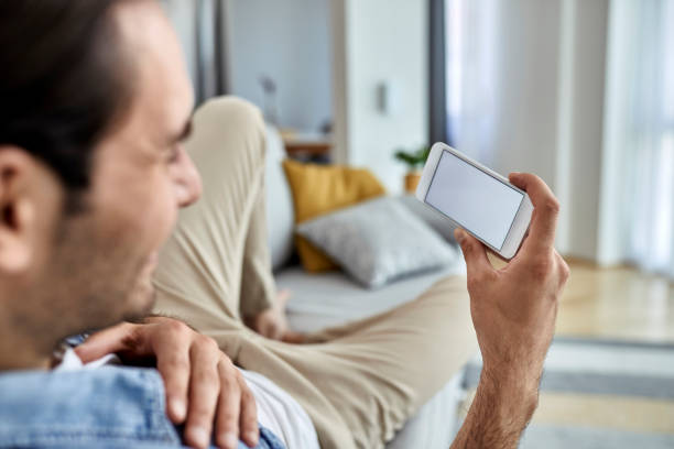 istock Close-up of man using smart phone at home. 1243246246