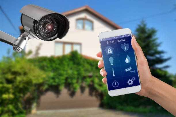 camera and private house on the background Security camera and smart home app, private house on the background home security