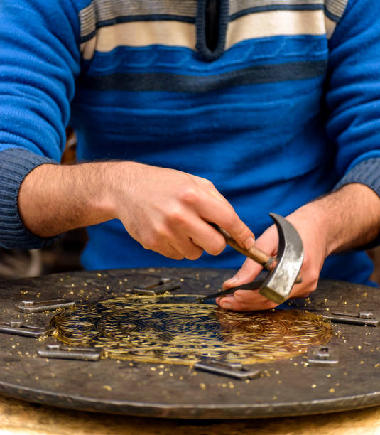 istock Hands of Craftsman Engraving Brass Plate 1243247190