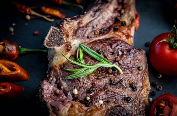 istock Roasted piece of beef with vegetables on the kitchen 1243247204