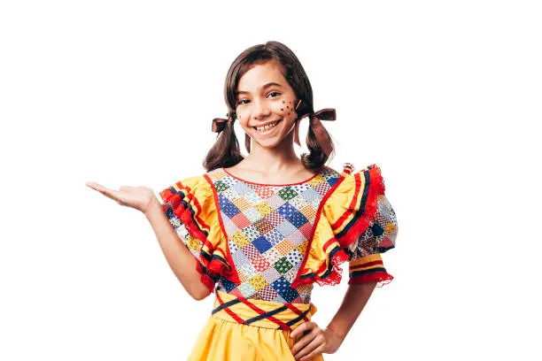 Photo of Brazilian woman wearing typical clothes for the Festa Junina showing something isolated on white background