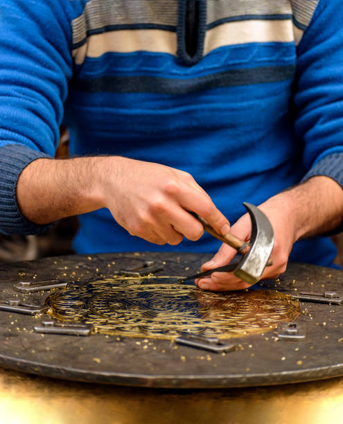 istock Hands of Craftsman Engraving Brass Plate 1243250012