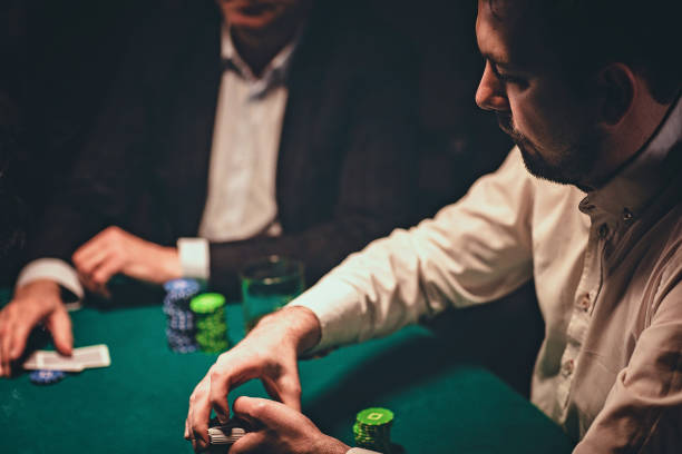 istock Two gentlemen playing poker in casino 1243256868