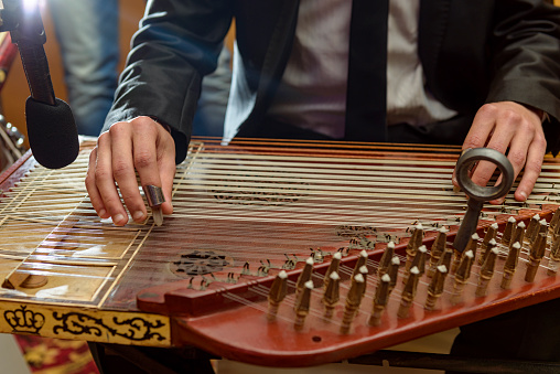 Male Hands Playing Arabian Qanon Musical Instrument During a Symphony