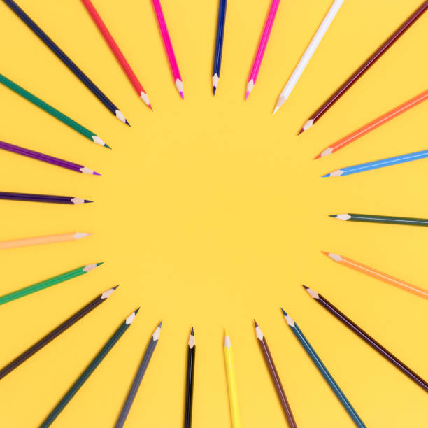 istock Circle frame made of colorful pencils on a yellow background. 1243267297