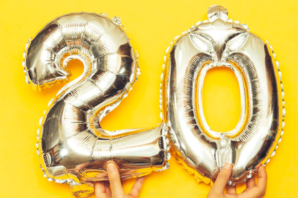 istock hands holding Silver Foil Balloon Number 20 1243269544