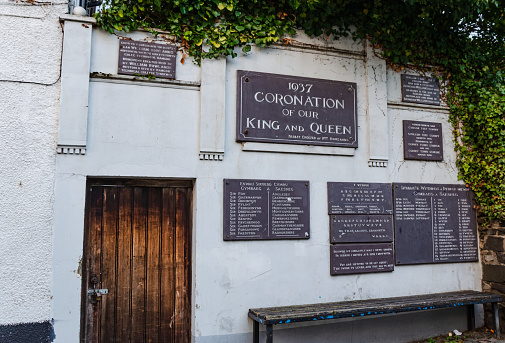 Conwy, Wales, UK: Nov 24, 2017: An unusual monument of bi-lingual slate plaques on Chapel Street was erected by William Rowlands to commemorate the coronation of King George VI at Westminster Abbey.