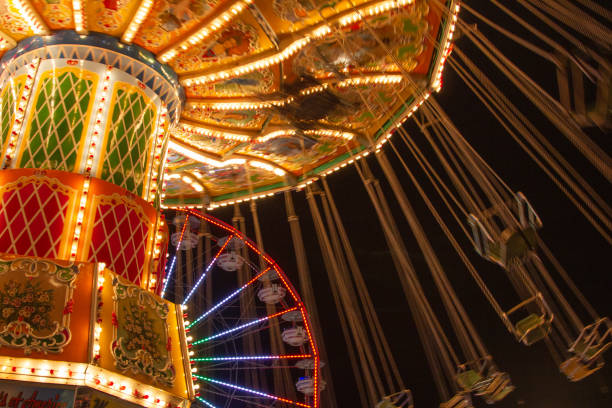 istock Swing ride with lights at a carnival at night 1243286471