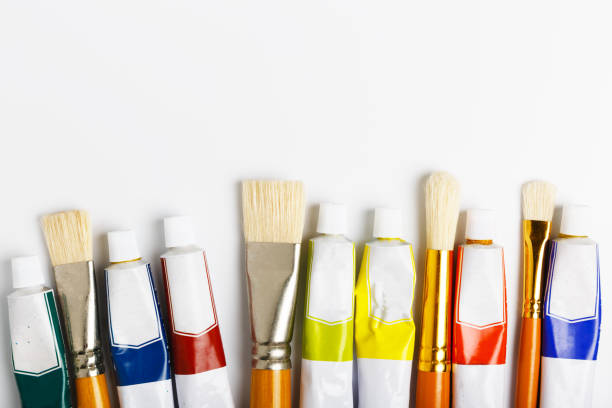 istock paint brushes and tubes with oil paint on a white background. 1243296422