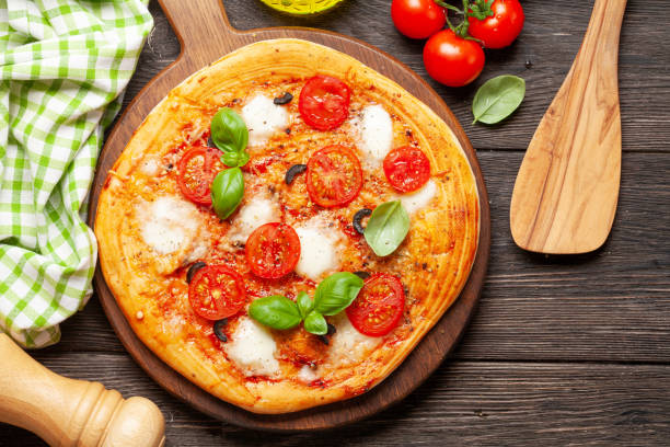 istock Tasty homemade pizza with tomatoes and basil 1243297985