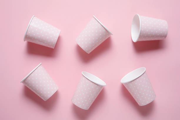 istock Pattern from six Pink Paper Drinking Cups on pink Backgrounds. Birthday Party Celebration Abstract Fashion Baby Shower Concept. Pastel Colors. Minimalist Style 1243301973