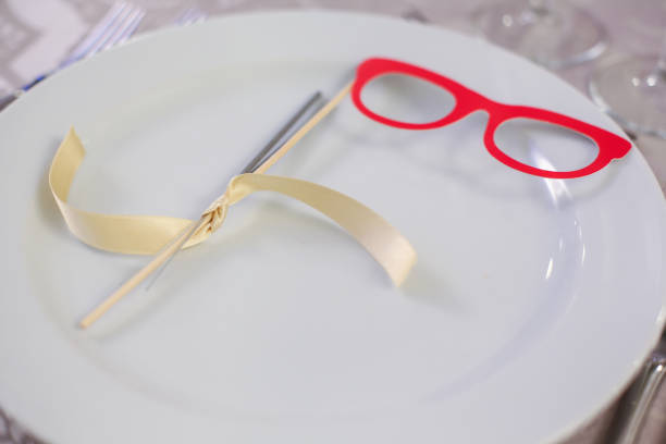 Photo booth props glasses on white plate