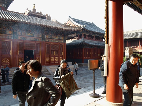 Beijing, China - October 31, 2010: Unidentified believers are praying inside the Lama Temple, Beijing, China. The Lama Temple was the residence palace of Yongzheng Emperor and Qianlong Emperor when they were a princes. The palace was changed to a lama temple after they became kings.