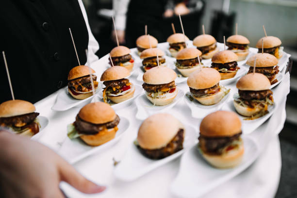 photo of small burgers in a wedding small burgers in a wedding canape stock pictures, royalty-free photos & images
