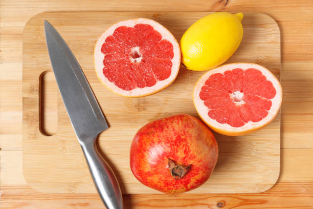 lemon, grapefruit, pomegranate in the form of a cut on a bamboo wood Board