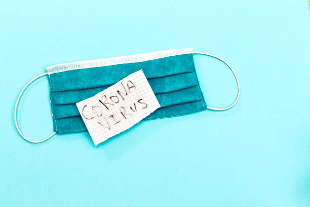 istock tear paper with coronavirus concept and blue mask 1243326477