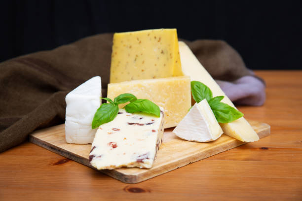 istock Many cheeses laying on wooden board 1243339268