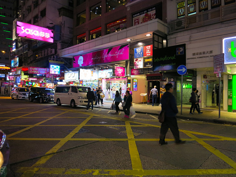 Hong Kong, Hong Kong - 12 04 2017: Hong Kong crosswalk in business financial district downtown neon lights.