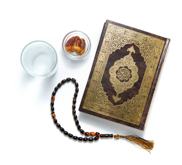 istock Quran Holy Book, Water, Dates and Rosary, Isolated on White 1243348979