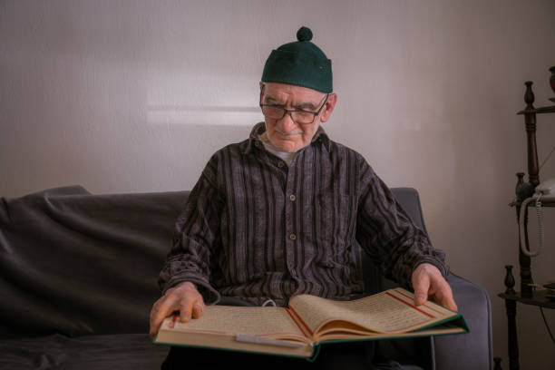 istock muslim old man is reading quran 1243357477