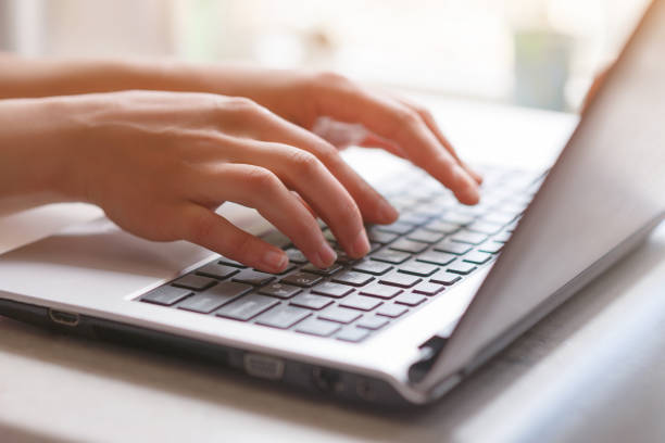 istock Woman working at home office hand on keyboard close up 1243363656