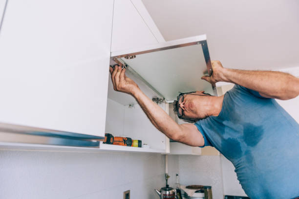 istock repairman repairs kitchen cabinets 1243364753