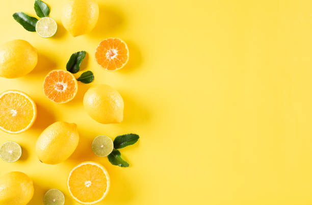 istock Summer composition made from oranges, lemon and green leaves on pastel yellow background. Fruit minimal concept. Flat lay, top view, copy space. 1243369625
